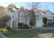 Inviting two-story home featuring stone accents, a manicured lawn, and an attached garage at 2125 Arbor Vista Dr, Charlotte, NC 28262