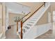 Bright foyer with staircase and hardwood floors leading into the living area at 2125 Arbor Vista Dr, Charlotte, NC 28262
