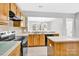 Spacious kitchen featuring an island, light countertops and matching wooden cabinetry at 2125 Arbor Vista Dr, Charlotte, NC 28262