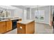 Bright kitchen with island, wood cabinets, and modern lighting fixtures at 2125 Arbor Vista Dr, Charlotte, NC 28262