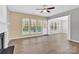 Spacious living room with large windows, fireplace, and modern hardwood floors at 2125 Arbor Vista Dr, Charlotte, NC 28262