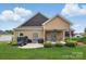 Backyard view of patio with ceiling fan, lush lawn, and mature landscaping at 307 Jaida Ln, Oakboro, NC 28129