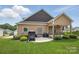 Home's backyard includes a patio, outdoor seating, and well-maintained landscaping at 307 Jaida Ln, Oakboro, NC 28129