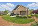 Backyard view featuring a patio, lush lawn, and mature trees at 307 Jaida Ln, Oakboro, NC 28129