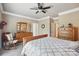 Serene bedroom with hardwood furniture, carpeted floors, rocking chair, and a soothing ambiance at 307 Jaida Ln, Oakboro, NC 28129