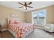 Bright bedroom with ceiling fan, one window, and a colorful patterned bedspread at 307 Jaida Ln, Oakboro, NC 28129