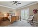 Comfortable bedroom with hardwood furniture, ceiling fan, and a rocking chair near a door to the outside at 307 Jaida Ln, Oakboro, NC 28129