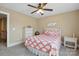 Tan bedroom with a white bed, neutral decor, and ceiling fan providing a relaxing atmosphere at 307 Jaida Ln, Oakboro, NC 28129