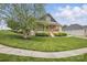 Well-manicured lawn and landscaped yard on a corner lot with covered porch at 307 Jaida Ln, Oakboro, NC 28129
