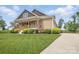 Well-kept lawn and home with covered porch and nice landscaping at 307 Jaida Ln, Oakboro, NC 28129