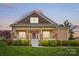 Charming home with a covered front porch, stone accents, and well-maintained landscaping at 307 Jaida Ln, Oakboro, NC 28129