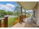 Relaxing covered front porch with wooden railings and seating at 307 Jaida Ln, Oakboro, NC 28129