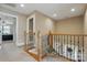 Hallway featuring hardwood railing and bannister overlooking a foyer with great natural light at 307 Jaida Ln, Oakboro, NC 28129