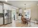 Modern kitchen with stainless steel appliances, neutral tile, and a cozy breakfast nook at 307 Jaida Ln, Oakboro, NC 28129
