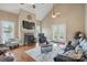Inviting living room with a fireplace, vaulted ceiling, and hardwood floors at 307 Jaida Ln, Oakboro, NC 28129