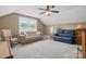 Carpeted living room with neutral walls, a window, a ceiling fan, and comfortable seating at 307 Jaida Ln, Oakboro, NC 28129