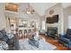 Open-concept living room with a fireplace, hardwood floors, and views into the kitchen at 307 Jaida Ln, Oakboro, NC 28129
