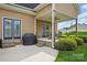 Covered outdoor patio featuring dining set and view of landscaped backyard at 307 Jaida Ln, Oakboro, NC 28129