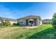 Charming backyard features a patio with seating, lush green lawn, and a well-maintained exterior at 314 Flat Rock Dr, Denver, NC 28037