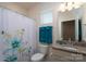 Bathroom with a toilet, sink, granite countertop, and curtained shower at 314 Flat Rock Dr, Denver, NC 28037
