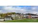 Beautiful community clubhouse with modern architecture, pool, and lush landscaping in a well-maintained setting at 314 Flat Rock Dr, Denver, NC 28037