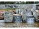 Striking community entrance with stone waterfall feature and prominent 'Trilogy' signage at 314 Flat Rock Dr, Denver, NC 28037