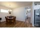 Comfortable dining area with warm lighting, a view to the entry and stainless fridge at 314 Flat Rock Dr, Denver, NC 28037