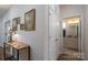 Inviting hallway with a decorative table, stylish lamp, and access to a pristine, well-lit bathroom at 314 Flat Rock Dr, Denver, NC 28037