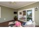 Relaxing covered patio with ceiling fan, outdoor furniture, and sliding door access to the living room at 314 Flat Rock Dr, Denver, NC 28037