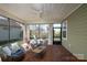 Screened patio with comfortable wicker seating, ceiling fan, and lovely views to the backyard at 314 Flat Rock Dr, Denver, NC 28037
