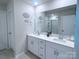 Modern bathroom with double sinks, large mirror, and a glass-enclosed shower, bright and functional at 314 Olympia Way, York, SC 29745
