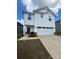 Two-story home features a clean white facade, attached garage, and a charming, covered front porch at 314 Olympia Way, York, SC 29745