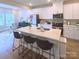 Modern kitchen features a large island with barstool seating and bright white cabinetry at 314 Olympia Way, York, SC 29745