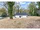 Exterior shot of home's rear and side, featuring grassy lot and mature trees at 315 Club House Dr, Salisbury, NC 28144