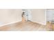 View of the bright bedroom with ensuite bathroom and doorway leading to the kitchen space, with modern hardwood floors at 315 Club House Dr, Salisbury, NC 28144