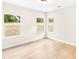 Bright bedroom featuring three windows offering natural light, complemented by hardwood flooring for a clean, modern aesthetic at 315 Club House Dr, Salisbury, NC 28144