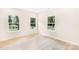Bright bedroom featuring three windows offering natural light, complemented by hardwood flooring for a clean, modern aesthetic at 315 Club House Dr, Salisbury, NC 28144