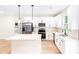 Modern kitchen featuring white cabinets, a central island, stainless appliances, and stylish pendant lighting at 315 Club House Dr, Salisbury, NC 28144