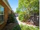 Brick home with a lush backyard, greenery, a mature trees, and pathway at 320 Falesco Ln, Matthews, NC 28105