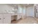 Bright bathroom with a soaking tub, glass shower, and dual vanity at 320 Falesco Ln, Matthews, NC 28105