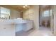 Bright bathroom with a vanity, shower-tub combo, and tiled floors at 320 Falesco Ln, Matthews, NC 28105