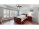 Comfortable bedroom with hardwood floors and shuttered windows at 320 Falesco Ln, Matthews, NC 28105
