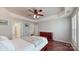 Comfortable bedroom with hardwood floors, tray ceiling, and a ceiling fan at 320 Falesco Ln, Matthews, NC 28105