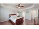 Comfortable bedroom with hardwood floors and views into the Primary bathroom at 320 Falesco Ln, Matthews, NC 28105