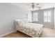 A bright bedroom featuring a ceiling fan and shuttered windows at 320 Falesco Ln, Matthews, NC 28105