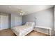 A neutral bedroom featuring a ceiling fan and double-door closet at 320 Falesco Ln, Matthews, NC 28105