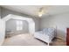 Bright bedroom with natural light from the window, ceiling fan, neutral walls, and closet at 320 Falesco Ln, Matthews, NC 28105