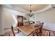 Dining room featuring a large wooden table, chandelier, and elegant decor at 320 Falesco Ln, Matthews, NC 28105