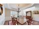 Dining room featuring a large wooden table, chandelier, and elegant decor at 320 Falesco Ln, Matthews, NC 28105
