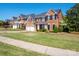 Charming brick home with black shutters, lush lawn, and two-car garage in a desirable neighborhood at 320 Falesco Ln, Matthews, NC 28105